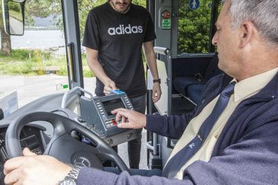 Un viajero de Monbus pasa su tarjeta TMG por la validadora